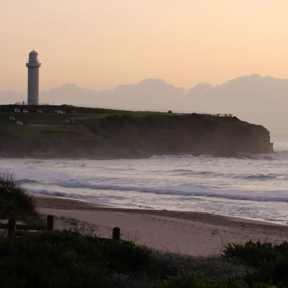 Scenic coastal view of Wollongong Lighthouse and beach at sunrise, symbolizing High Demand Restoration’s local expertise in water and flood restoration.