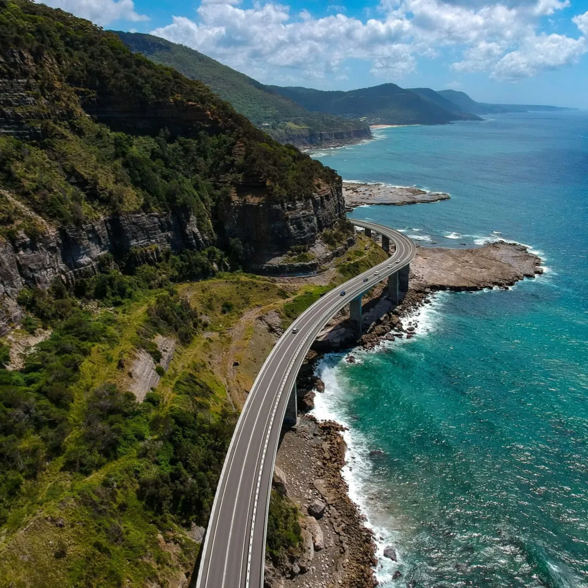 Aerial view of the iconic Sea Cliff Bridge along the Illawarra coastline, representing High Demand Restoration’s service coverage across the Wollongong and South Coast regions.