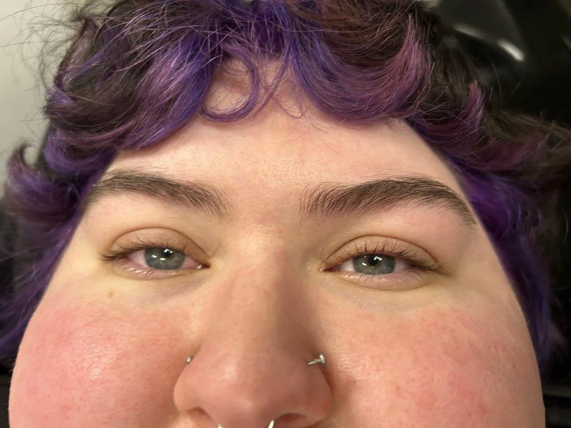 a lash lift done on a model with purple hair