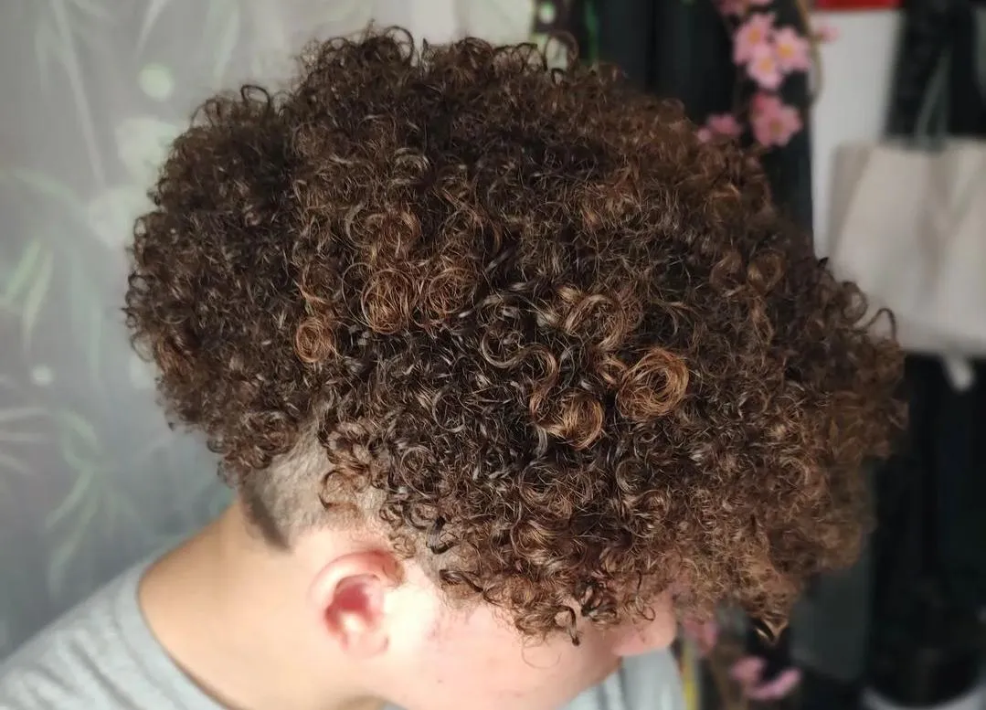 an example of a curly cut done on a model with a grey shirt