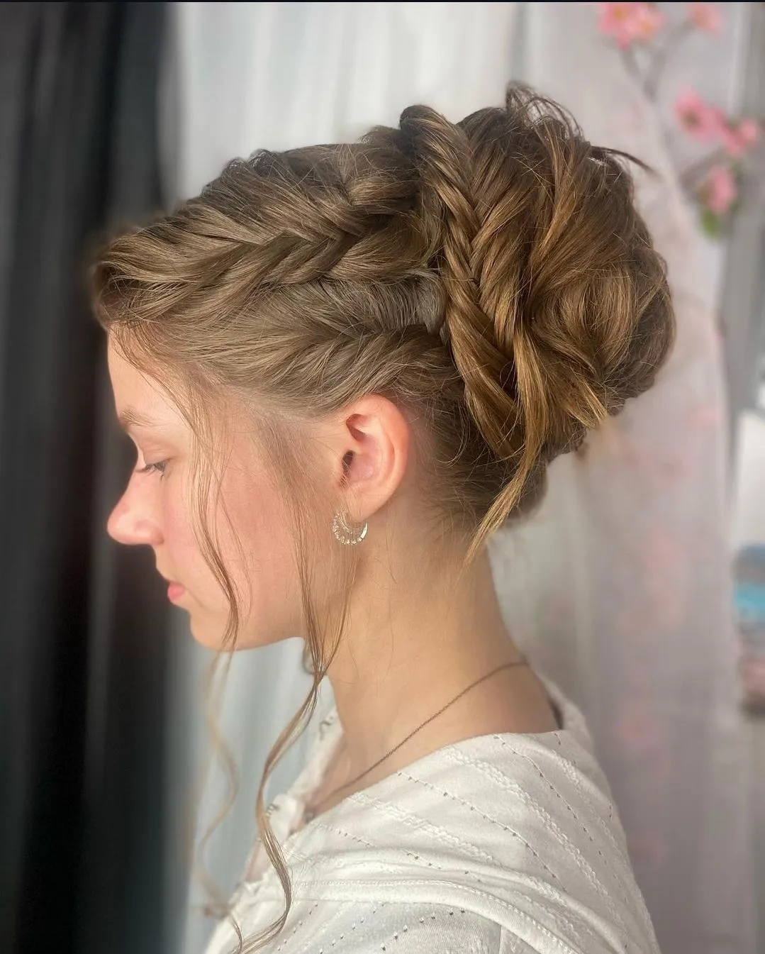 a complex twist up-do bun with a few pieces out