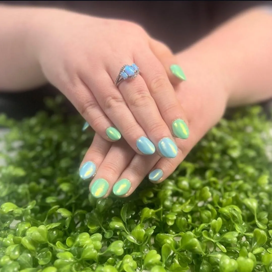 a set of green and blue chrome nails