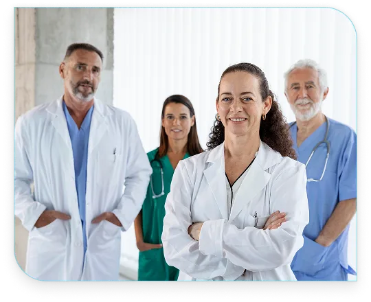 Confident team of diverse doctors and healthcare workers standing together in clinical attire.