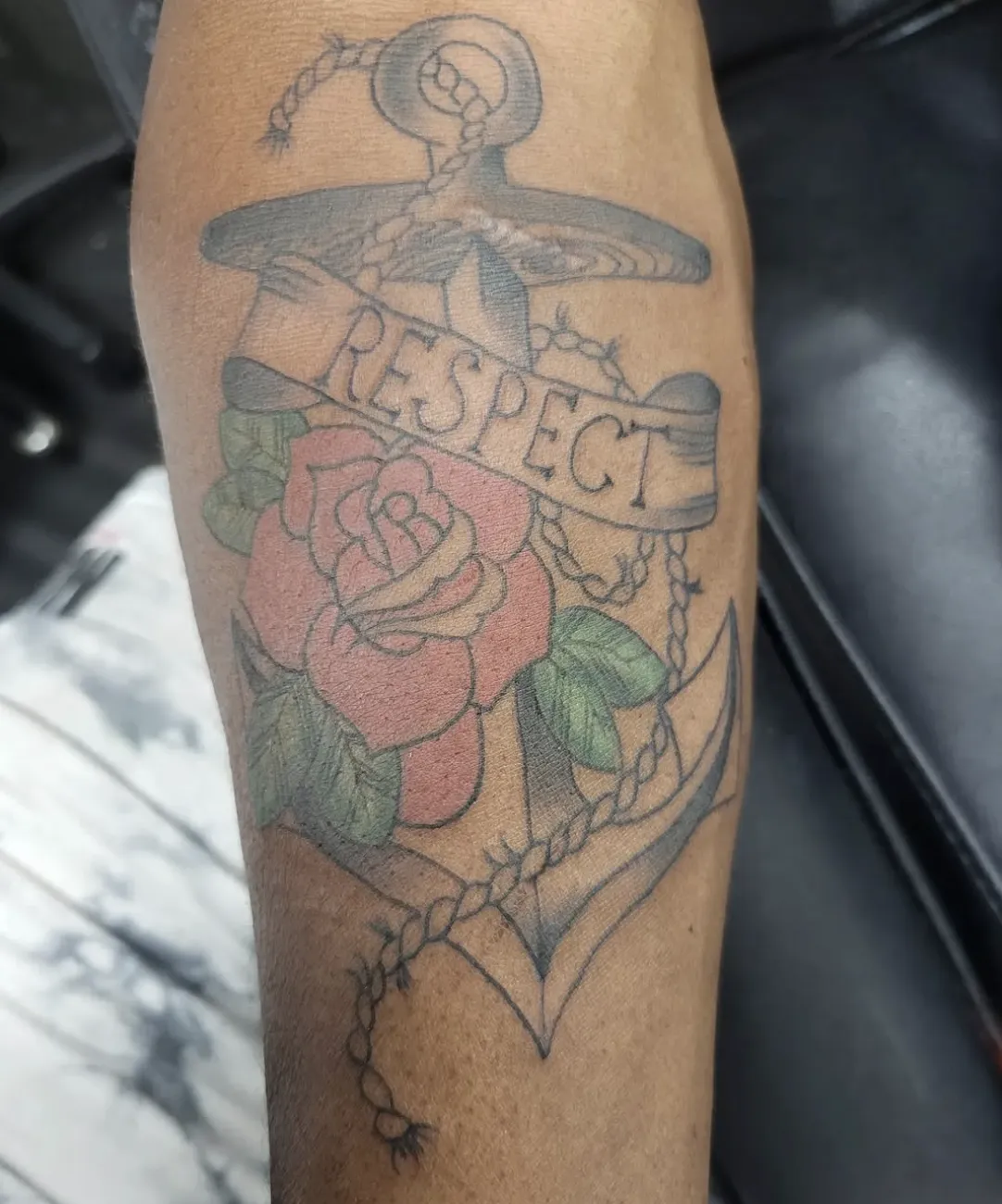 person in blue denim shorts and white nike sneakers standing on gray concrete floor