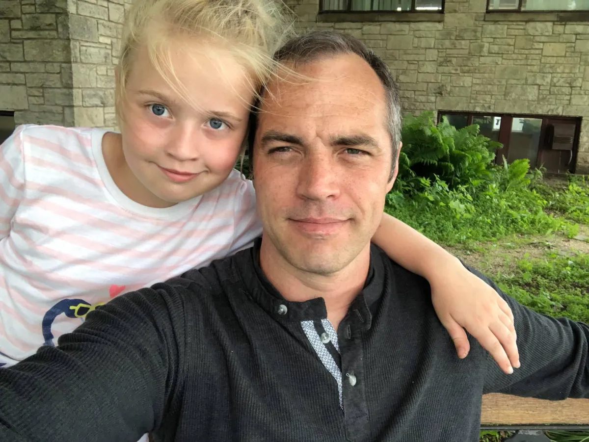 Pastor Jerry Simmons with his daughter enjoying a moment at home, near 238 Church in DeForest, Wisconsin.