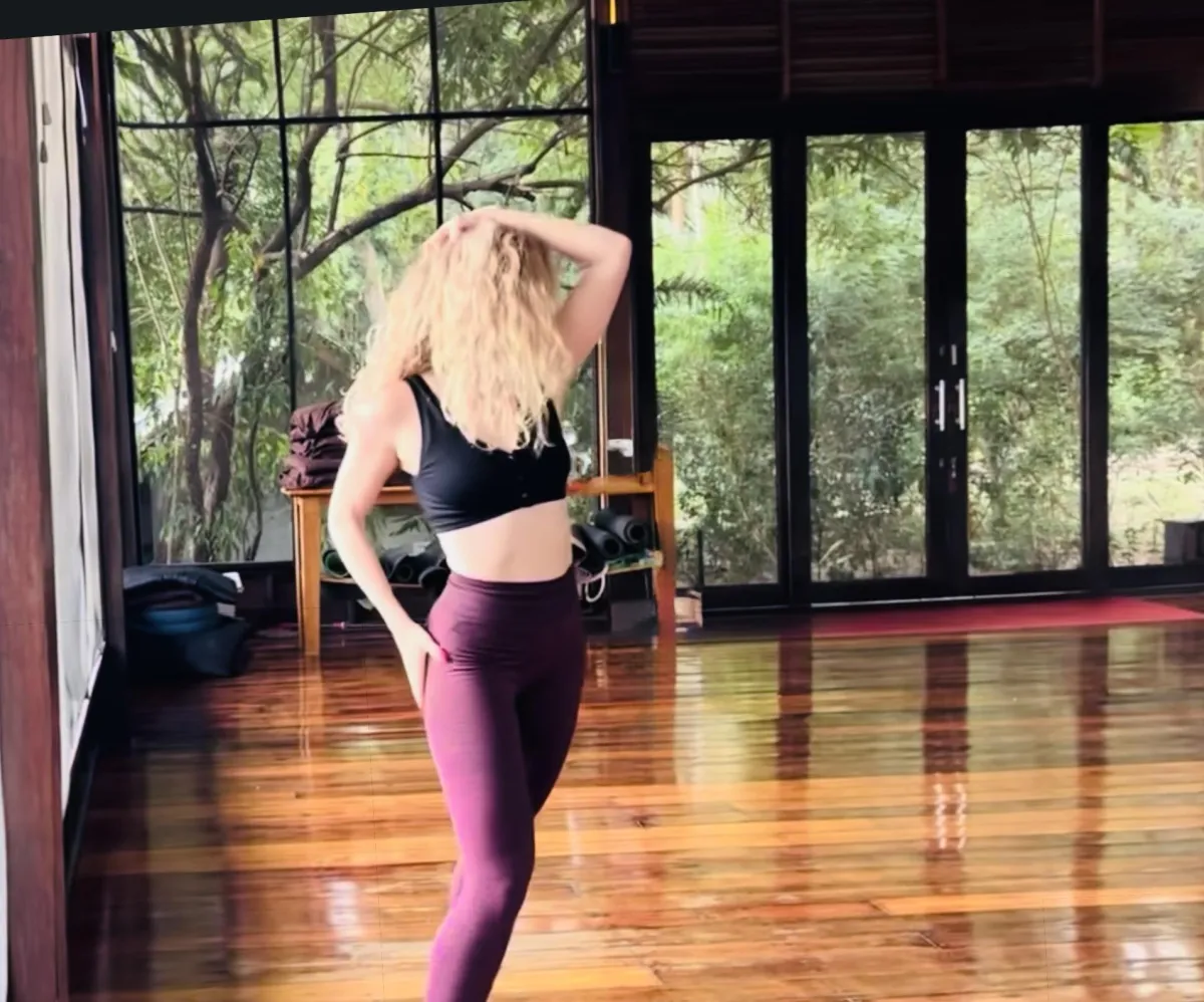 a group of women sitting outside in sunset meditating together as empowerment