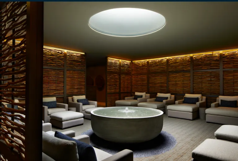 Calming cedar sauna detail with soft ambient light and folded linen towels
