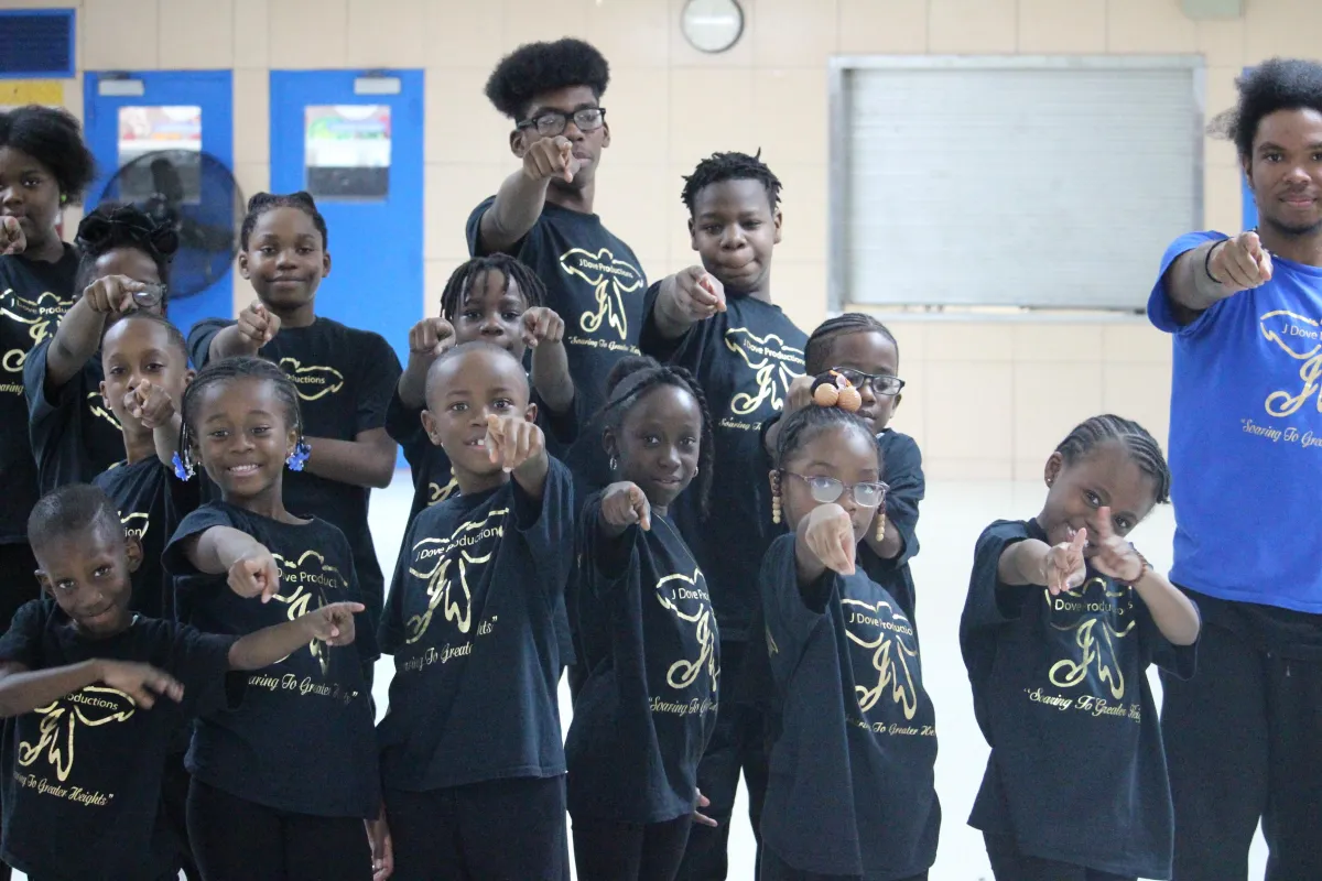 person lettering on tracing paper using mechanical pencil
