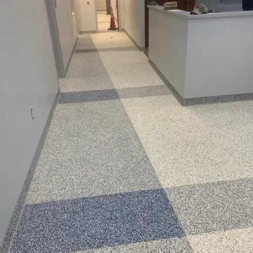 Durable epoxy garage floor installation in Sarasota, Florida with glossy protective finish.