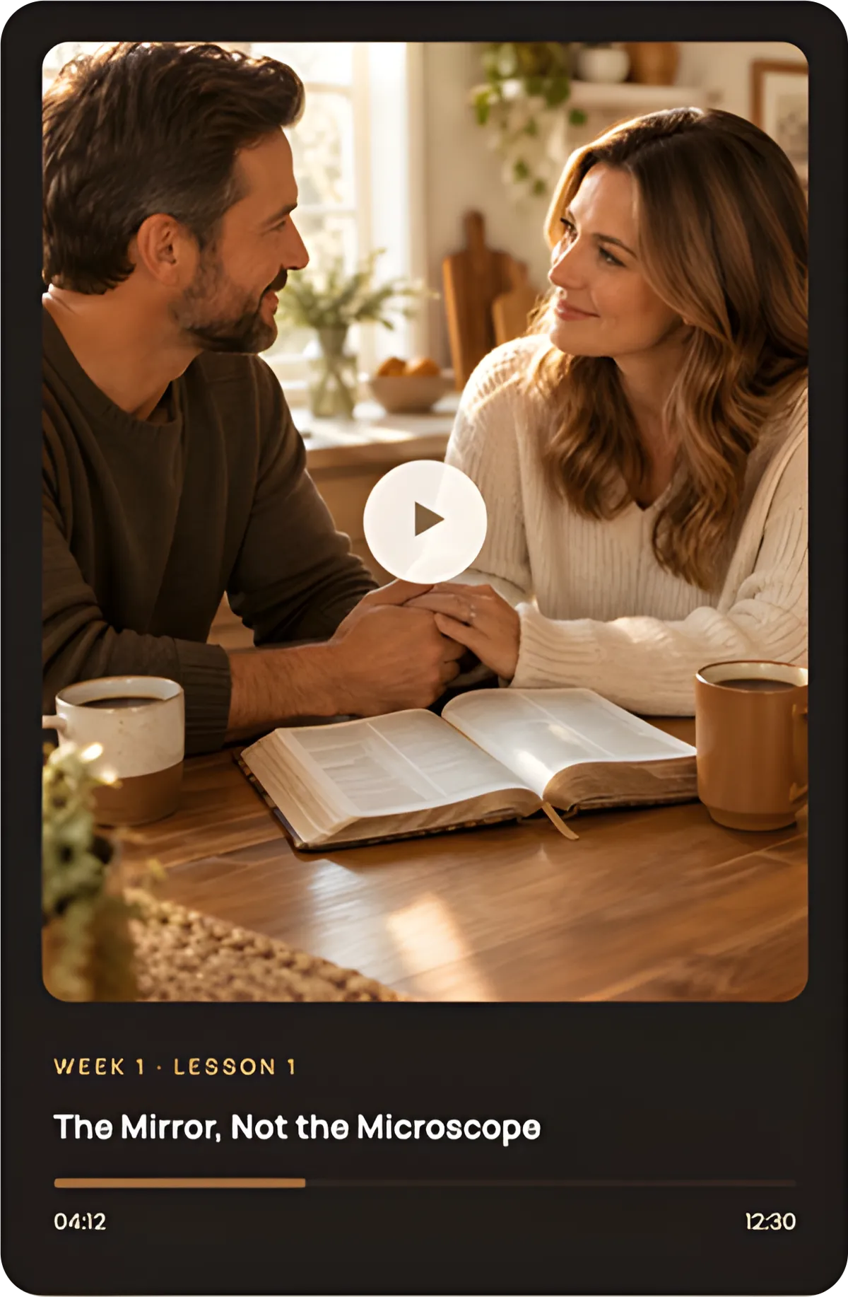 Tablet mockup showing a video player with a play button over an image of an open book on a wooden desk