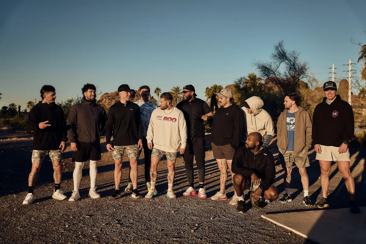 a couple of people walking along a beach next to the ocean