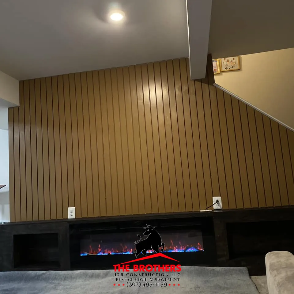 Modern interior wall panel installation with fireplace in Lewes Delaware home remodeling