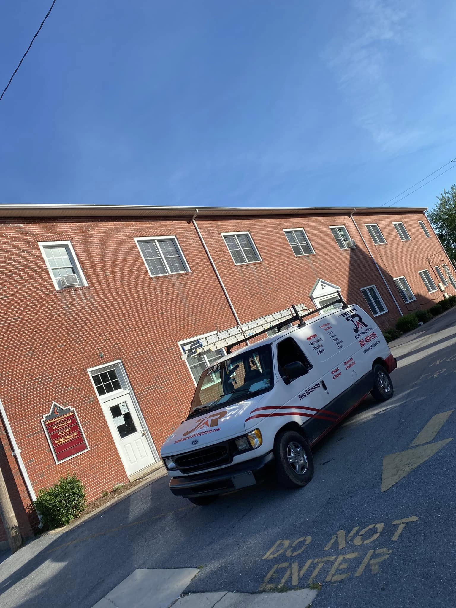 Construction company service truck parked at job site near building in Lewes DE