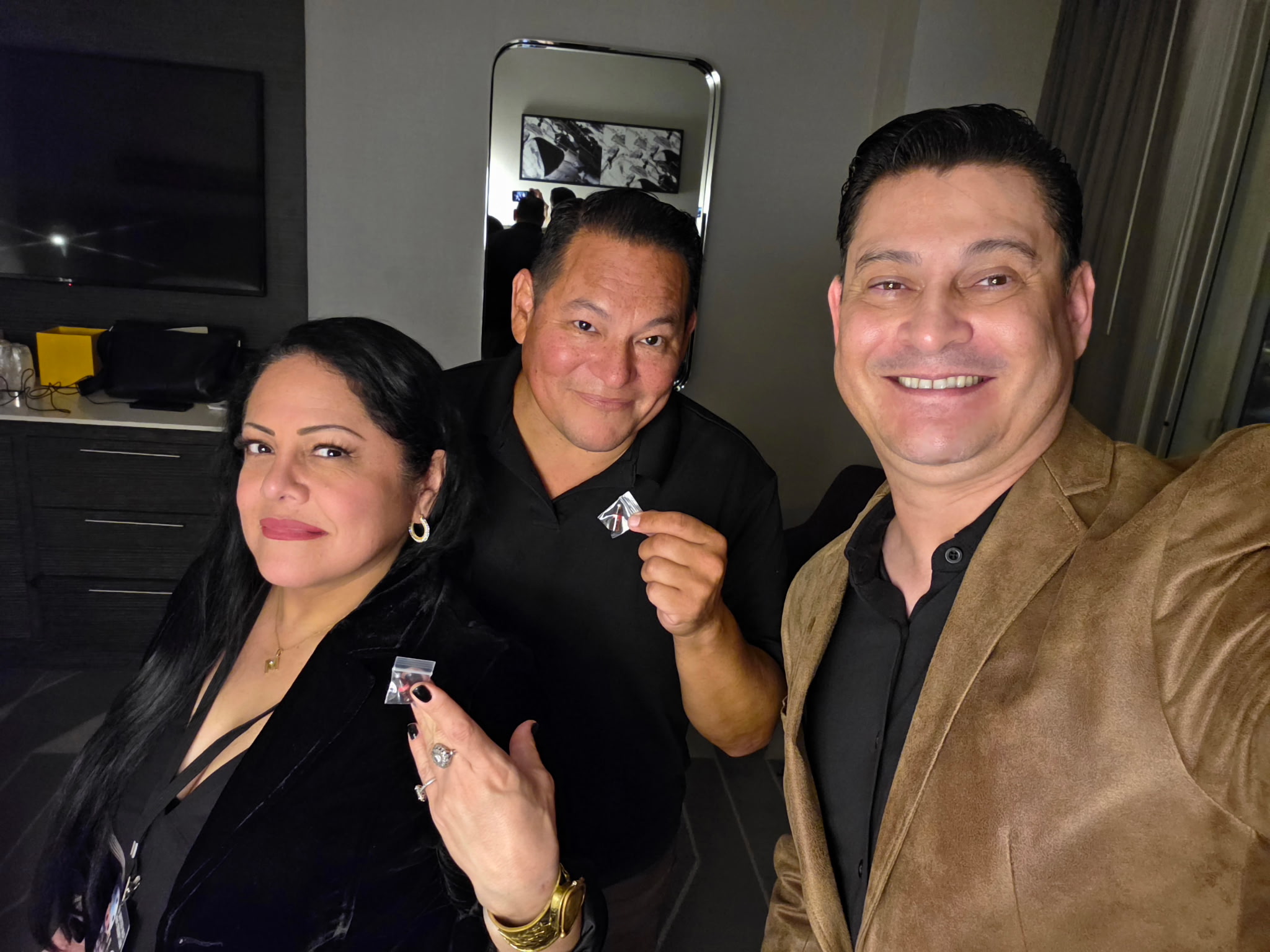 man in black polo shirt standing beside woman in black and white polka dot dress