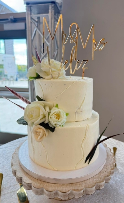 Layered tres leches cake slice with drizzle and garnish