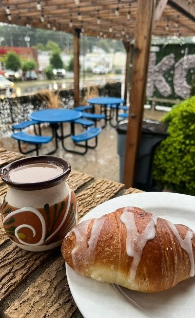 Layered tres leches cake slice with drizzle and garnish