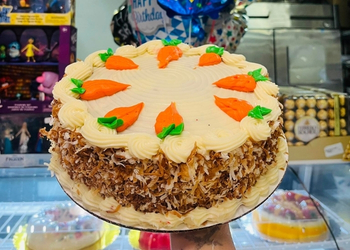 Freshly baked conchas and pan dulce on a wooden board.