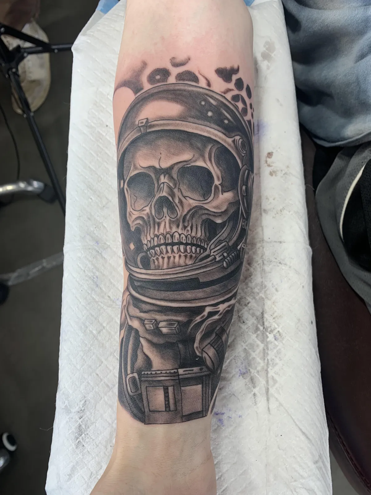 Botanical mandala wrapping a shoulder, layered petal patterns and delicate stippling; warm studio lighting, shallow depth of field, natural skin tones, photorealistic portrait orientation cropped square for gallery display.