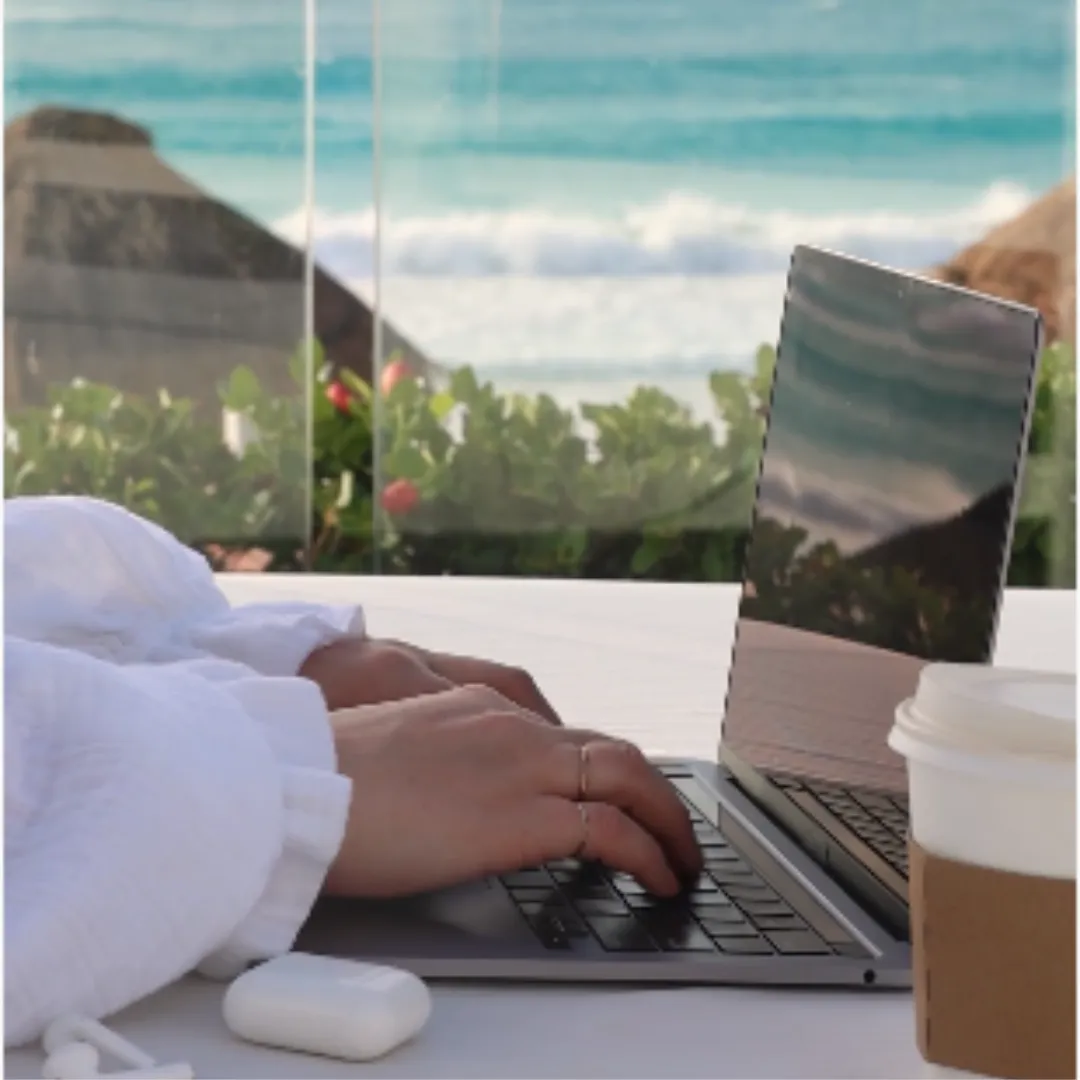 Laptop by the ocean representing flexible online business and work-from-anywhere lifestyle