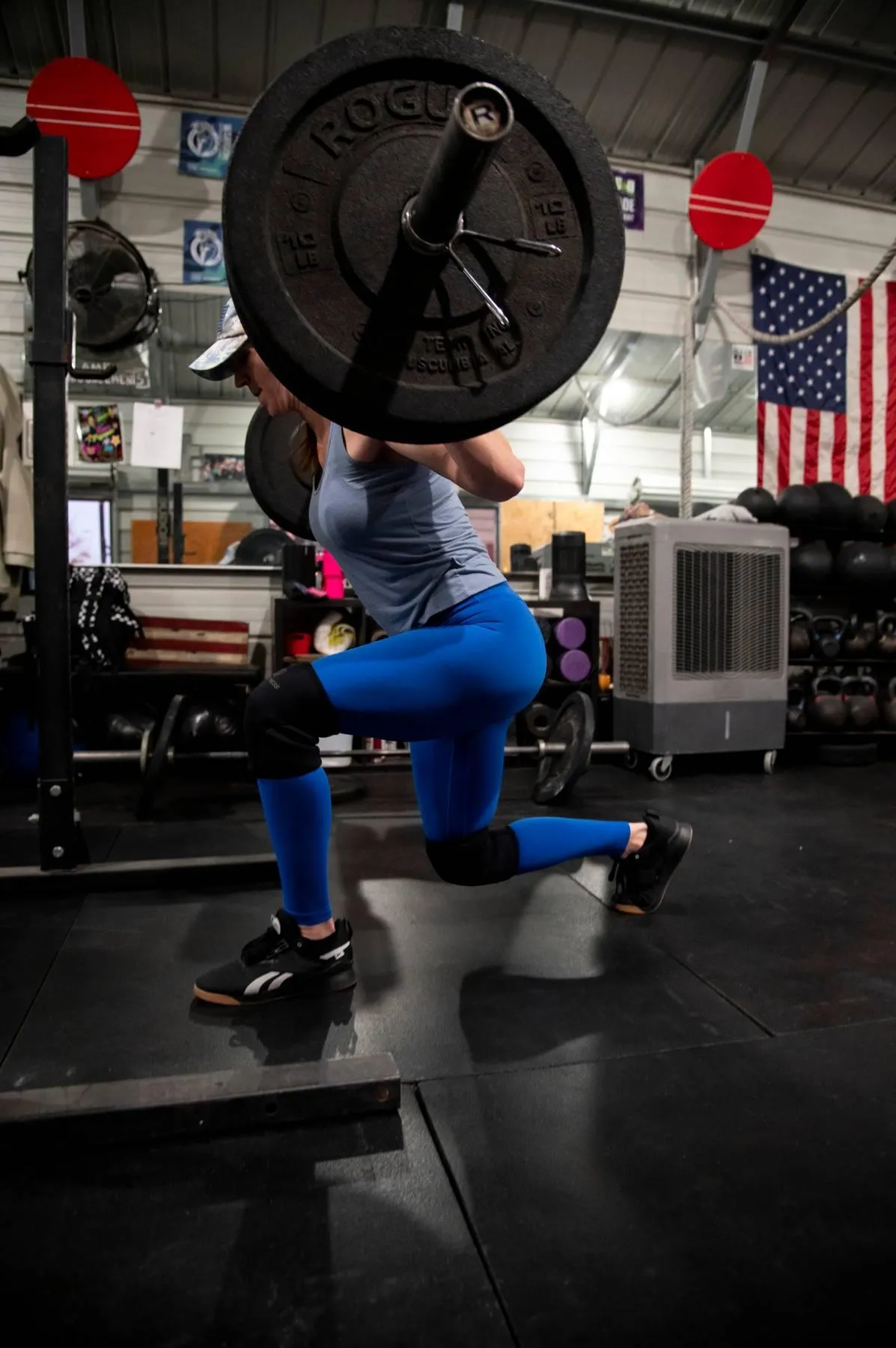woman carrying barbell