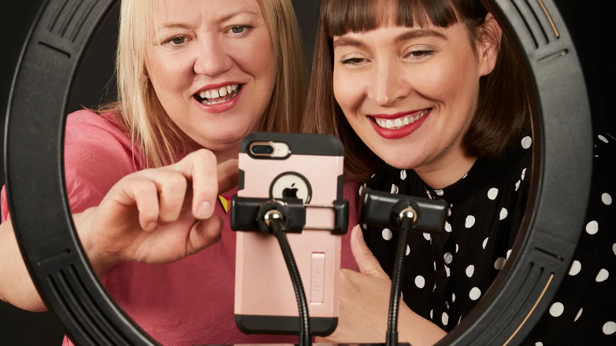 Mel showing TikTok on phone to demonstrate video content creation