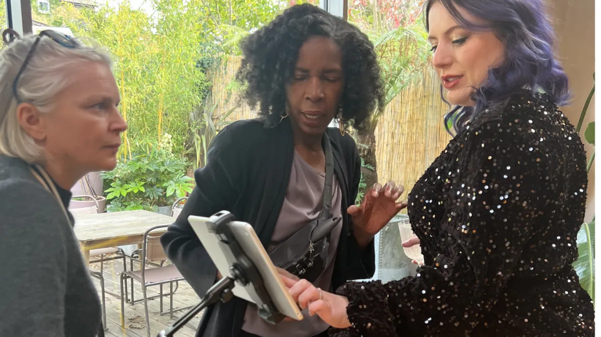 Mel showing TikTok on phone to demonstrate video content creation