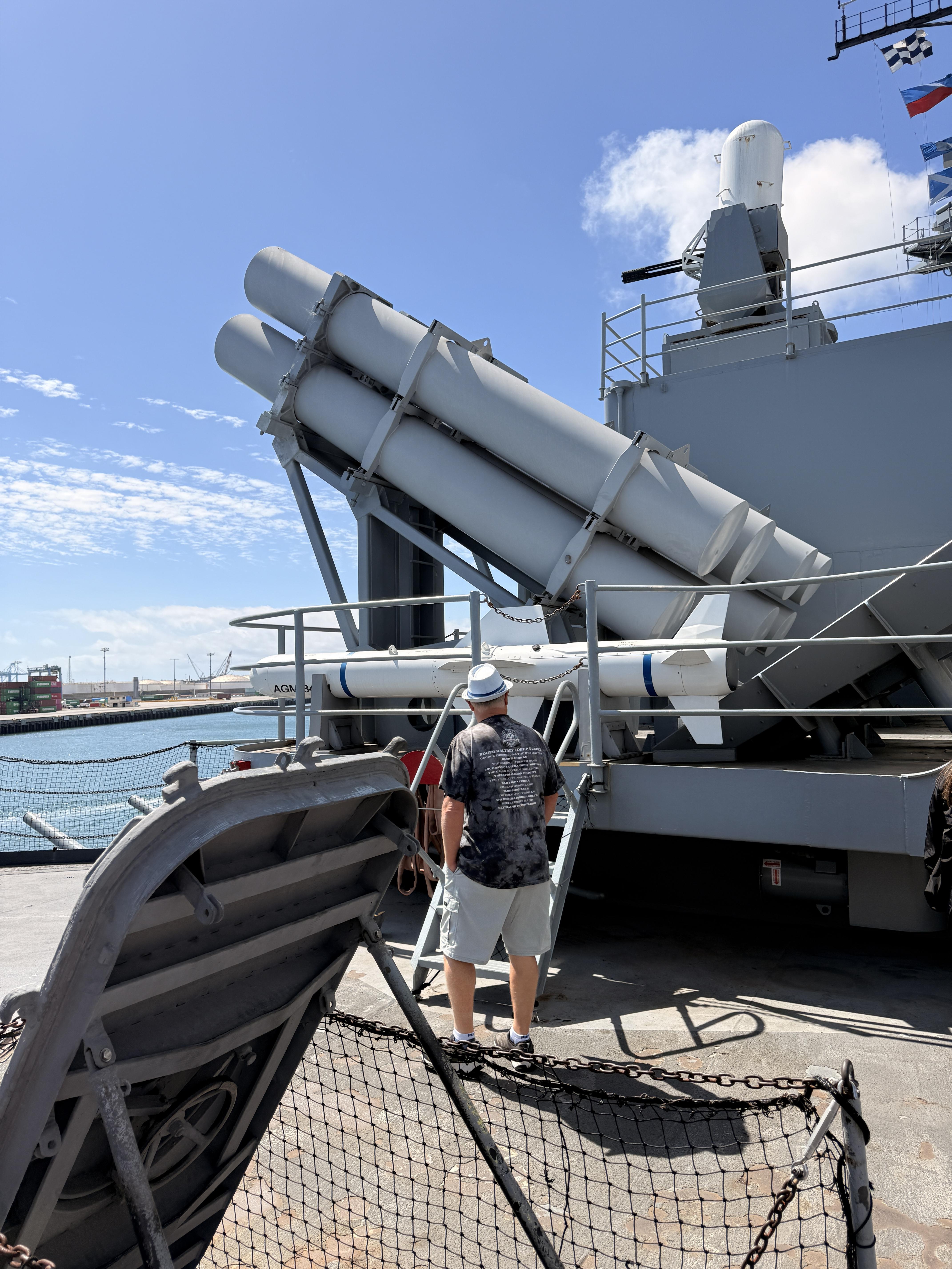 Visitors exploring the Harpoon missile launcher aboard the Battleship Iowa Museum in San Pedro California