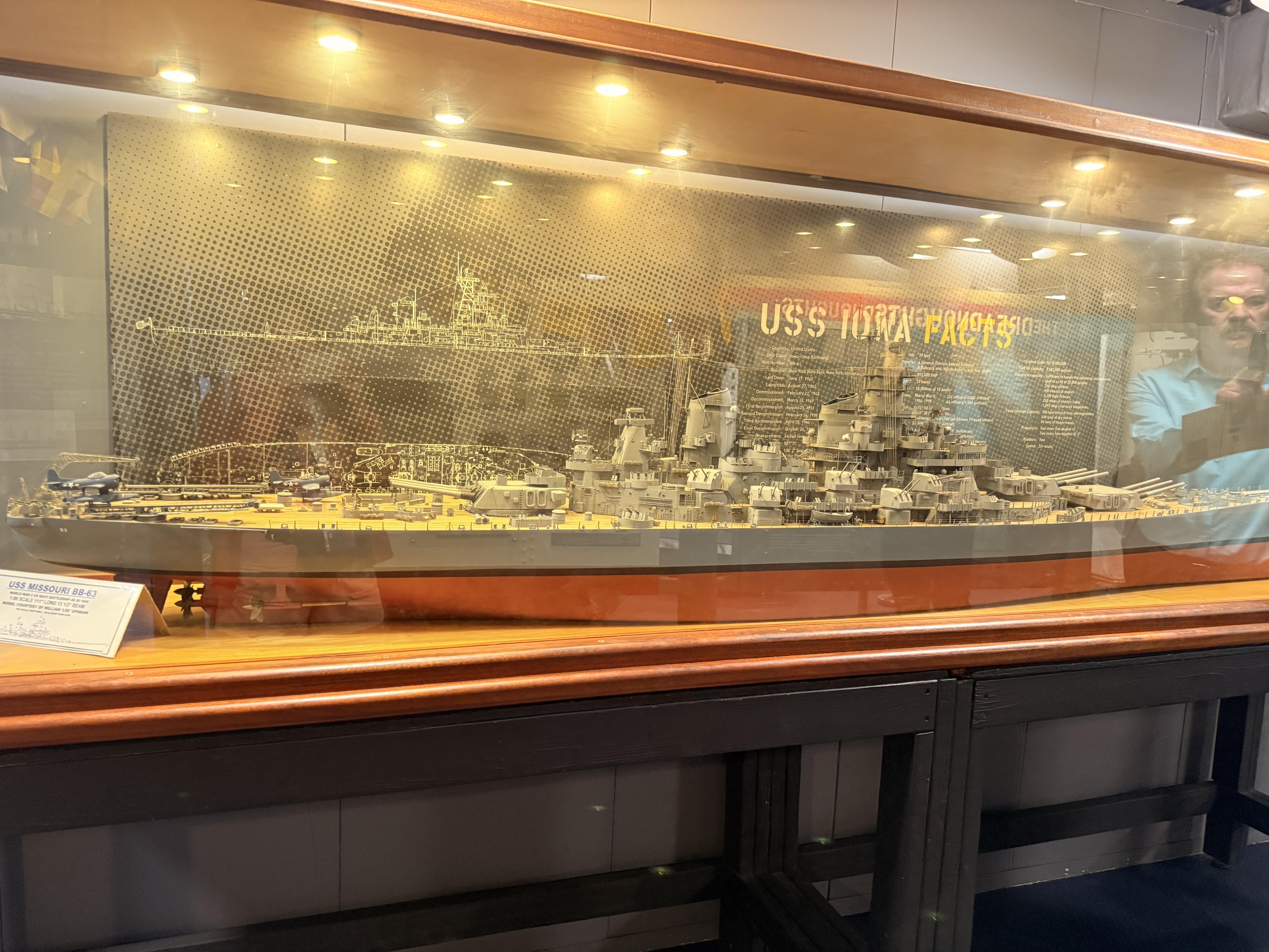 The USS Missouri BB-63 model in the display case inside, with "USS Iowa Facts" backdrop