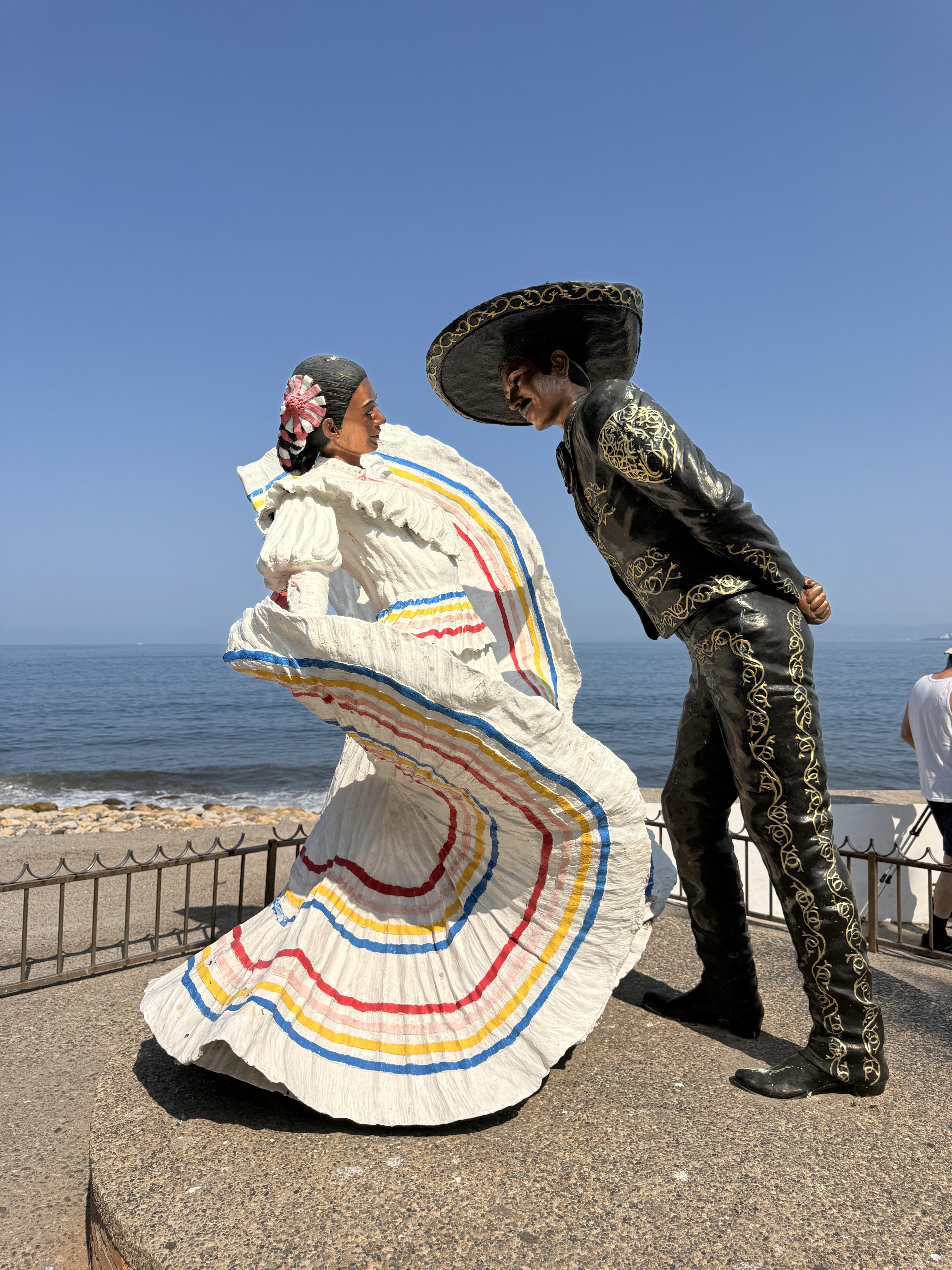 The folklórico dancers sculpture — a man in a charro suit and a woman in a swirling white and colorful dress —