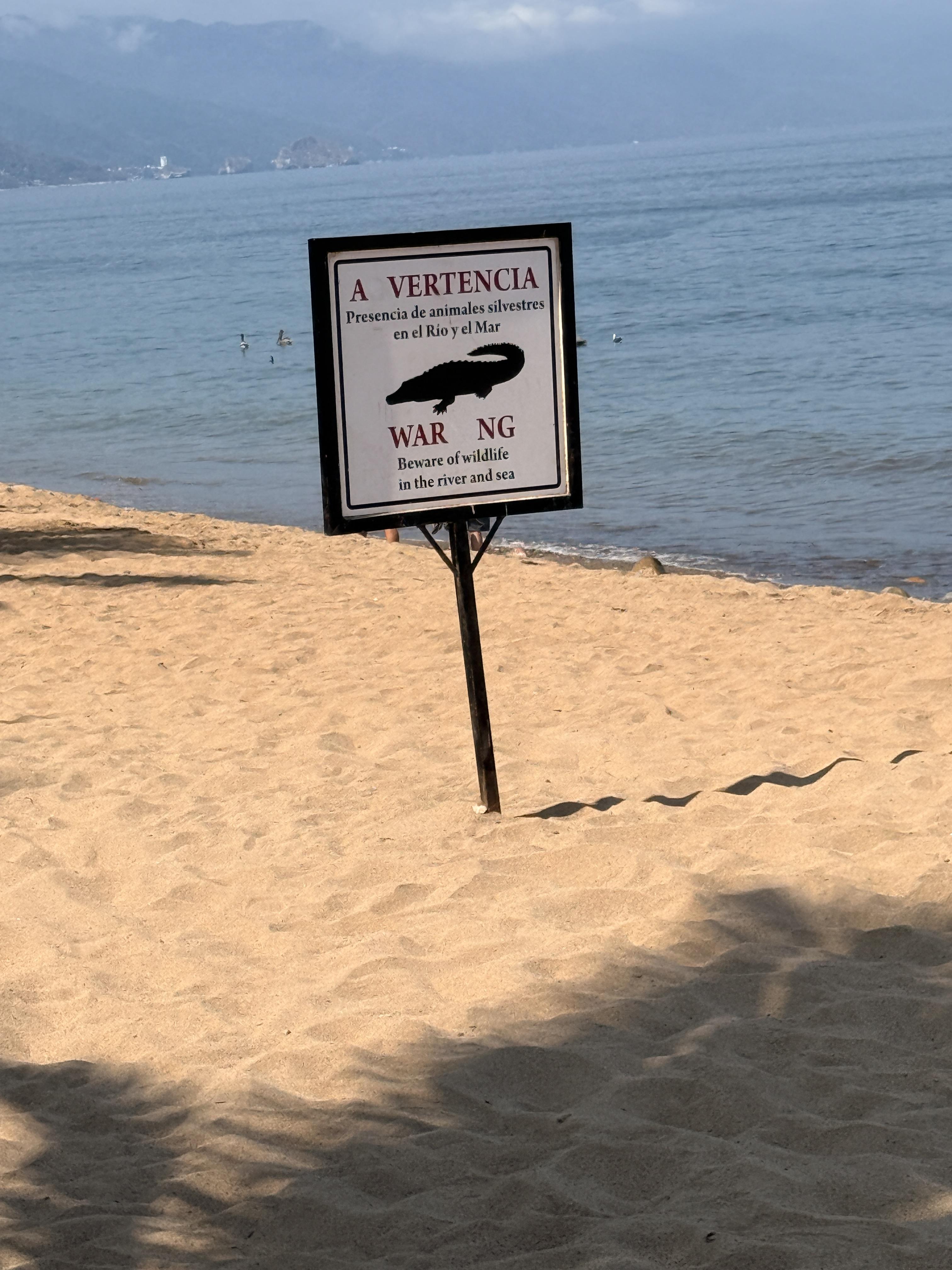 The signs warn of wildlife in both the river and the sea in the area