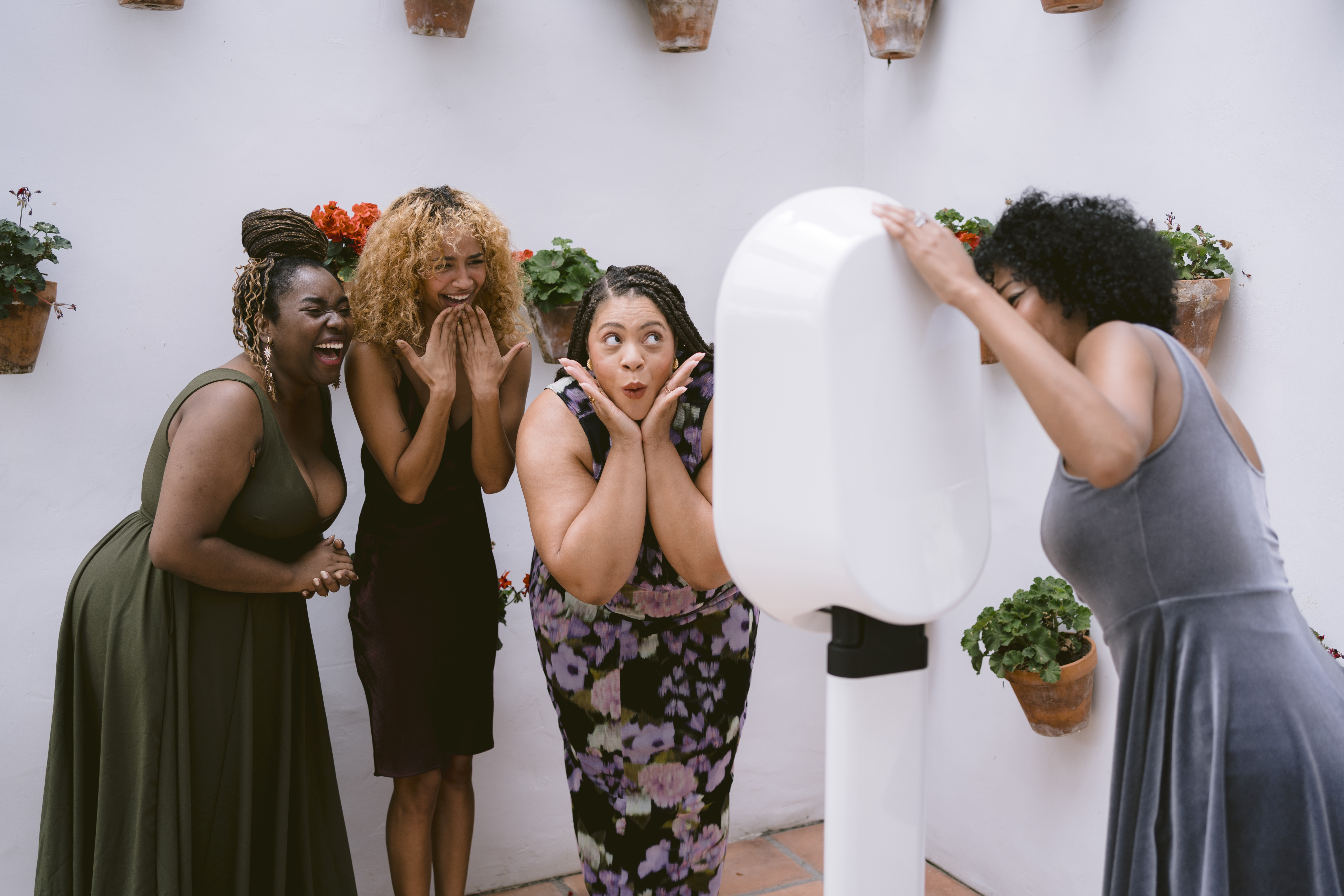 people making silly faces as they take a picture with a photo booth