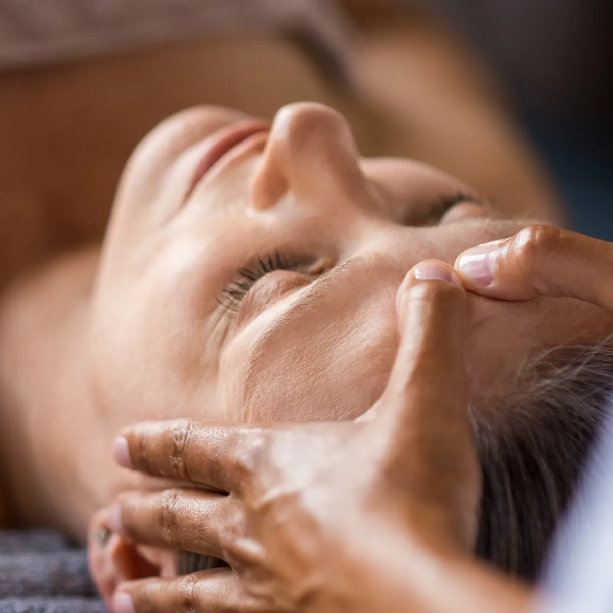 woman meditating on floor with overlooking view of trees