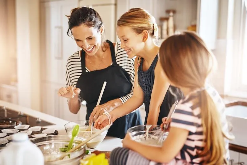 A family cooking food together in a kitchen