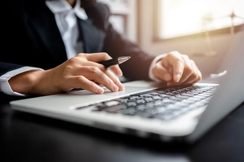An estate planning attorney working on a laptop