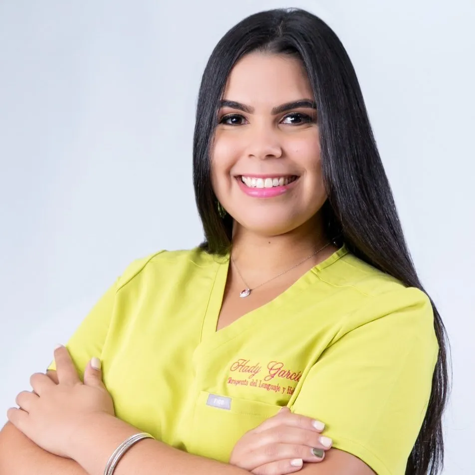 Portrait of a smiling female specialist in a bright yellow scrub top.