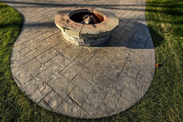 New organic shaped concrete patio with stone firepit in Mooresville NC