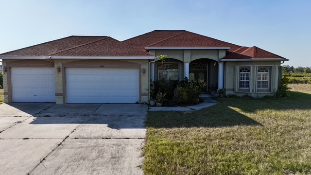 Front exterior of Punta Gorda home with 3 car garage