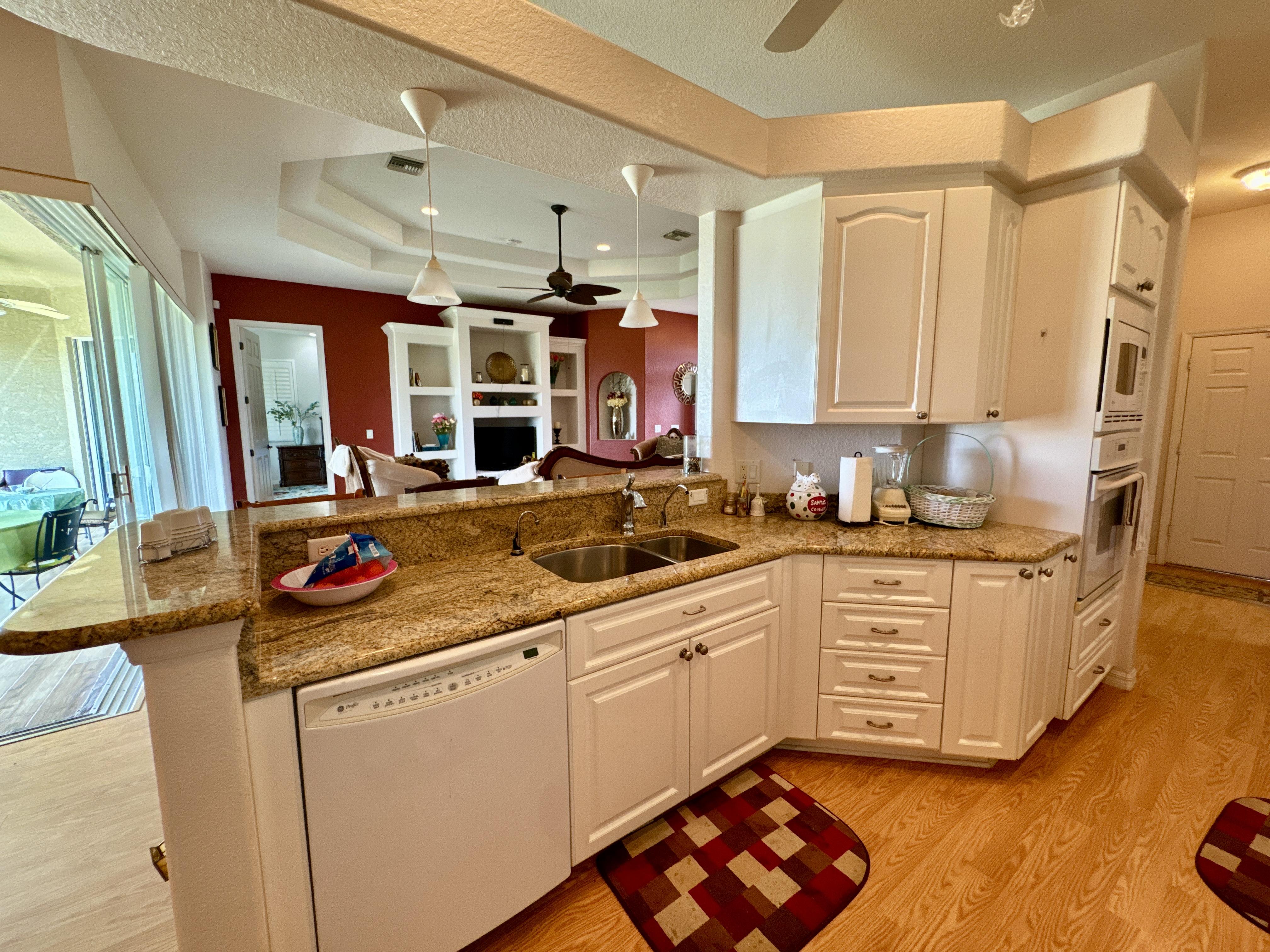Kitchen with granite countertops and white cabinets in Punta Gorda home