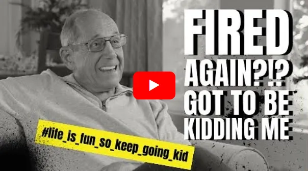 Elderly couple in golden late-afternoon light on a porch overlooking rolling fields.