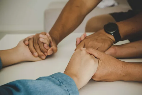 Holding hands in prayer