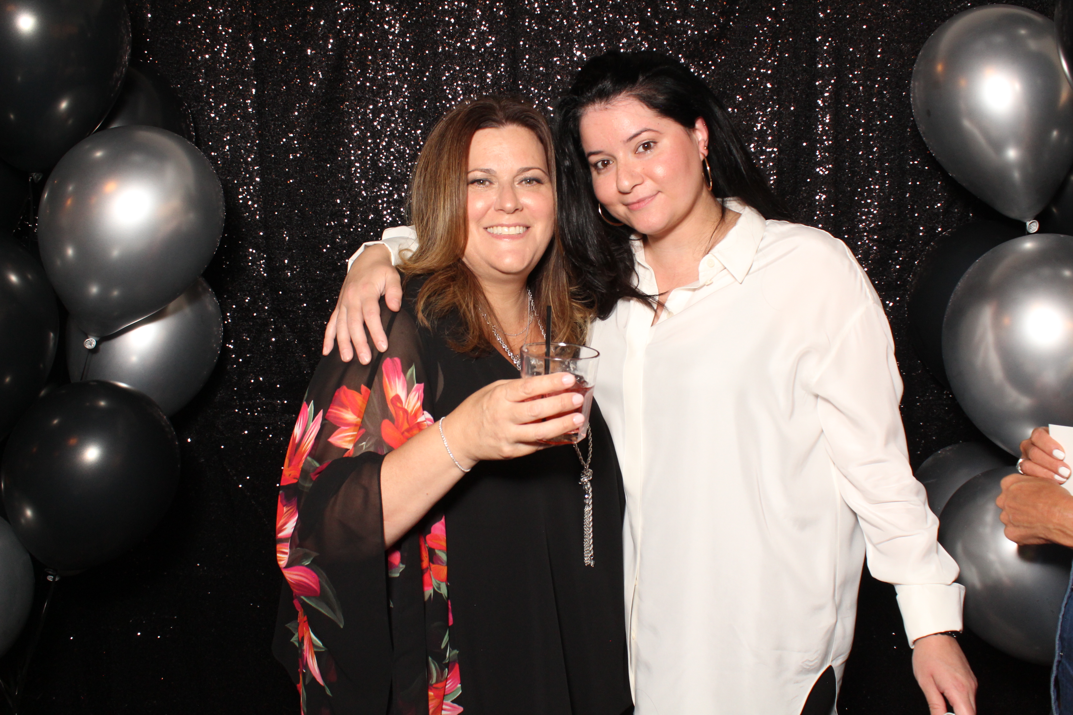 Guests posing in front of a premium black shimmer backdrop during a Vaughan Photo Booth rental