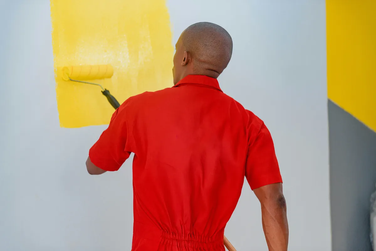 Painter painting an interior wall