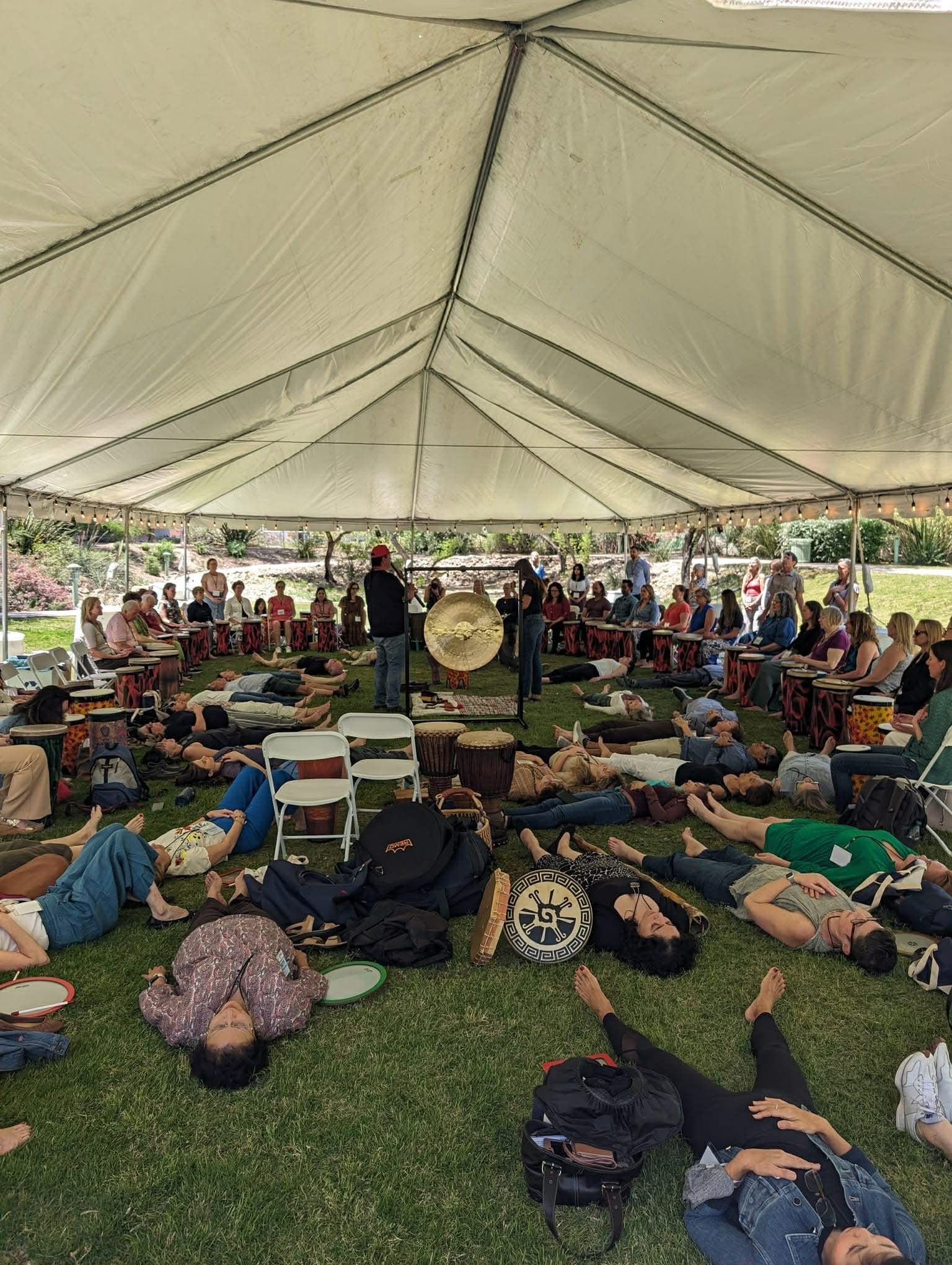People in a drum circle with warm candlelight