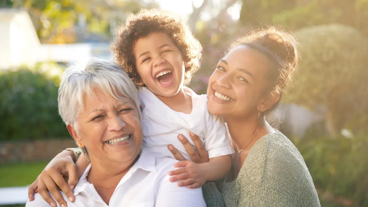 Three generations of a family smiling together