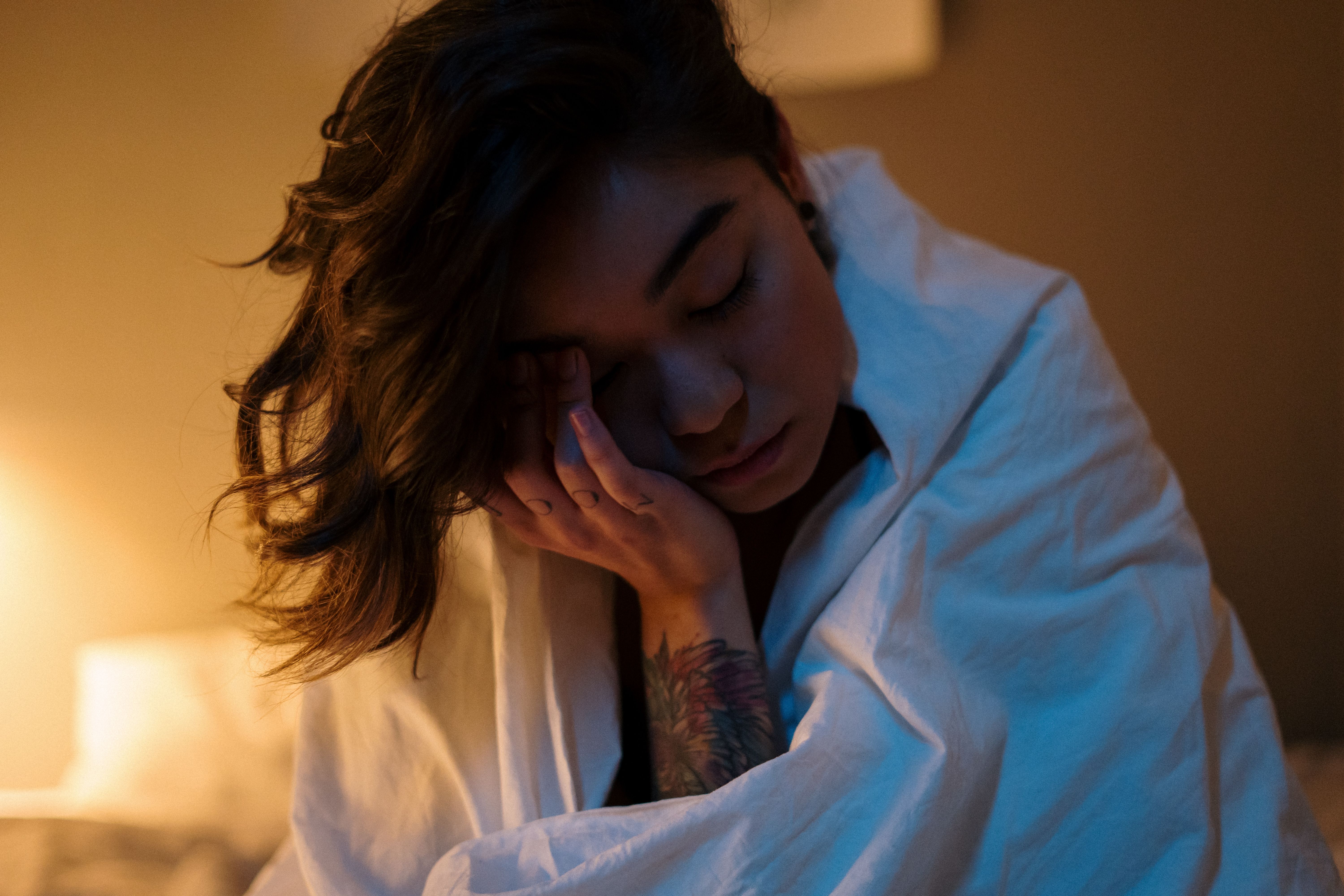 A woman in bed, exhausted and needing deep, restful sleep