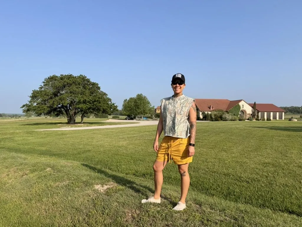 Minister ASii standing in a field in Texas. 