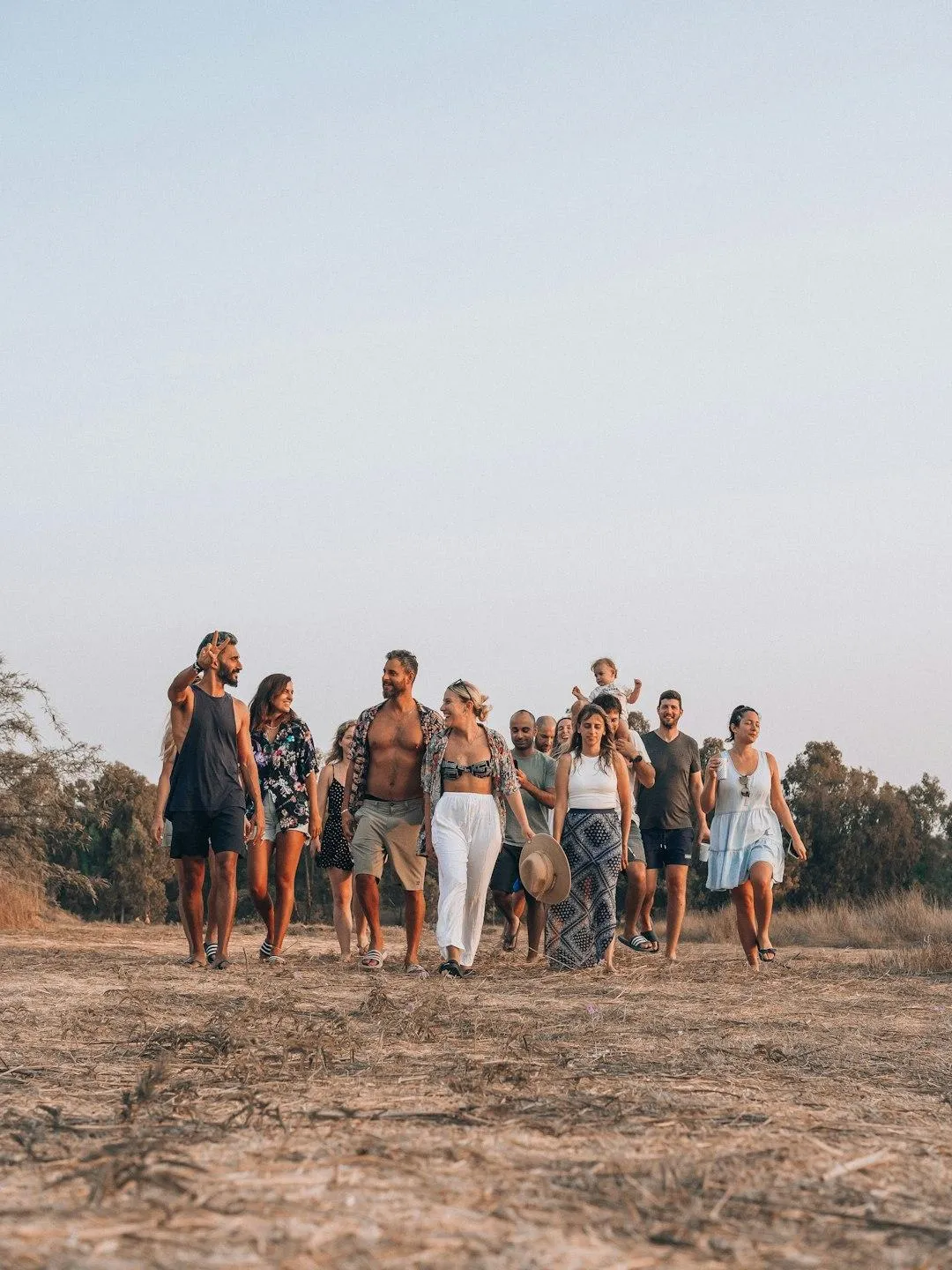 a group of people walking on a beach
