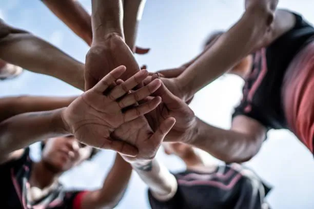 women forming heart gestures during daytime