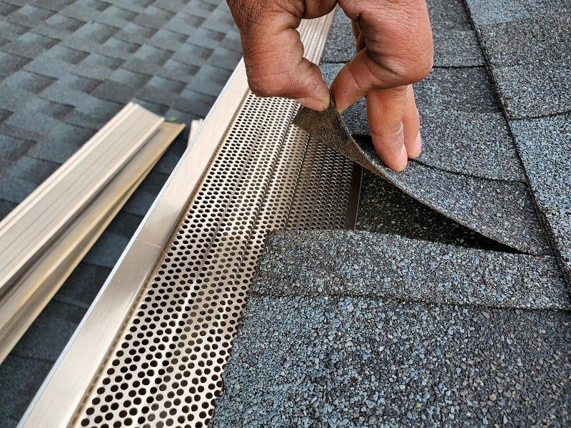 Team member installing mesh gutter guards on a home in Albany Ga