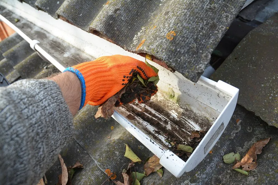 Dirty Gutter Being Cleaned By Gutter Repair Albany Team